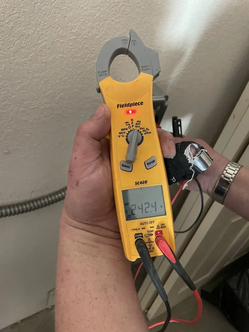 Voltage testing with clamp meter during Ceiling Fan Installation in Roxbury